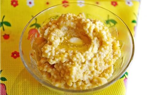 Porridge dorato con burro in una ciotola di vetro