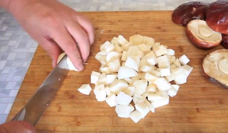 Tagliare a pezzetti le zampe dei funghi porcini.