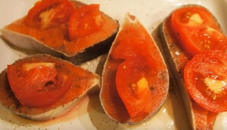 Su ogni pezzo di pesce mettiamo un cerchio di pomodoro.