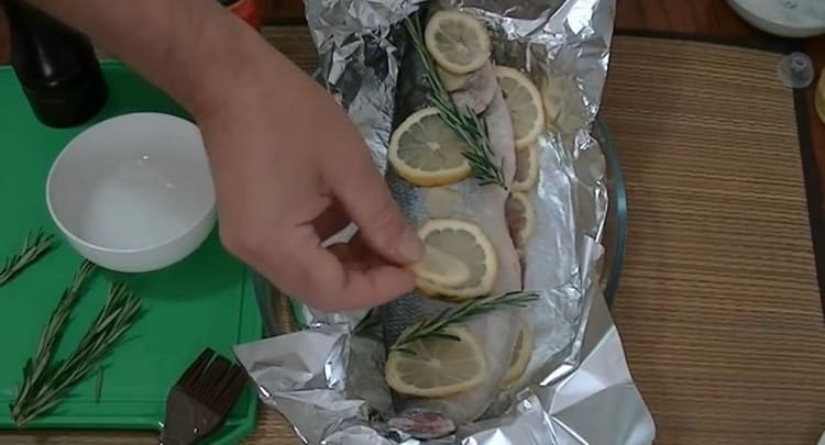 Sa tuktok ng mga isda, inilalatag din namin ang natitirang lemon, luya at rosemary.