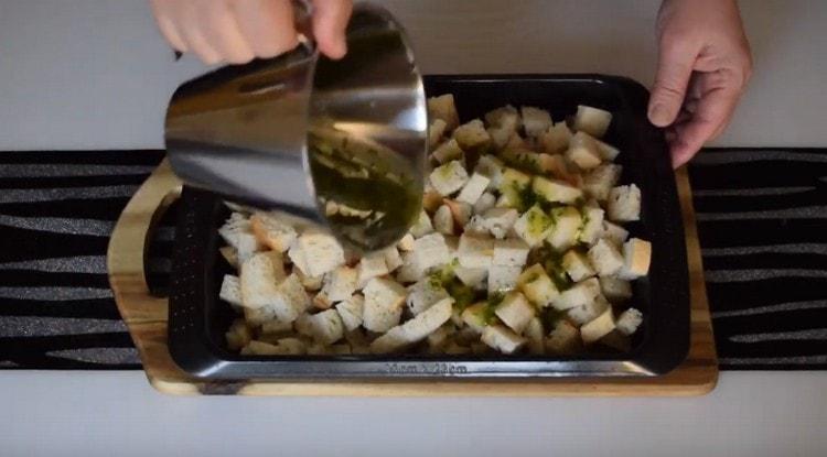 La miscela risultante viene innaffiata con fette di pane su una teglia e inviata al forno.