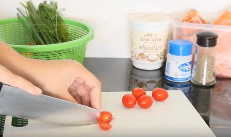 Tagliamo ogni pomodoro ciliegia in più pezzi.