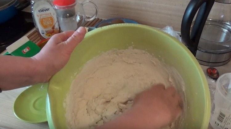 Innanzitutto, impasta l'impasto con un cucchiaio, quindi impasta con le mani.