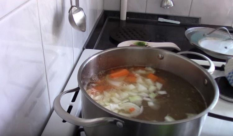 Distribuiamo le verdure in una padella con brodo.