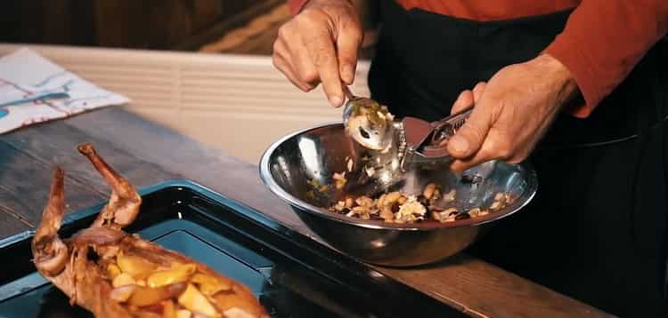 Cucinare l'intero coniglio nel forno. preparare un contorno