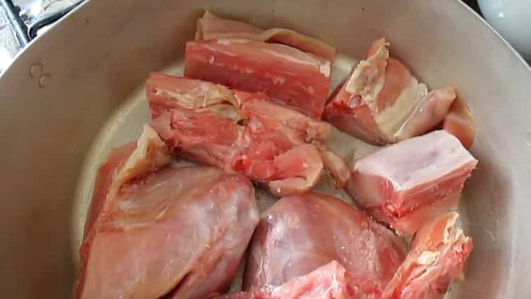 Per cucinare lo spezzatino di coniglio con le verdure, tagliare la carne