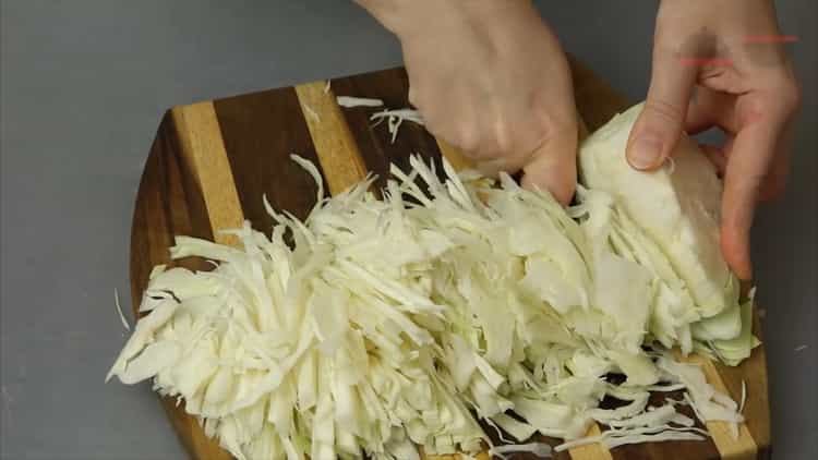 Per cuocere lo stufato di verdure in una pentola a cottura lenta, tagliare il cavolo