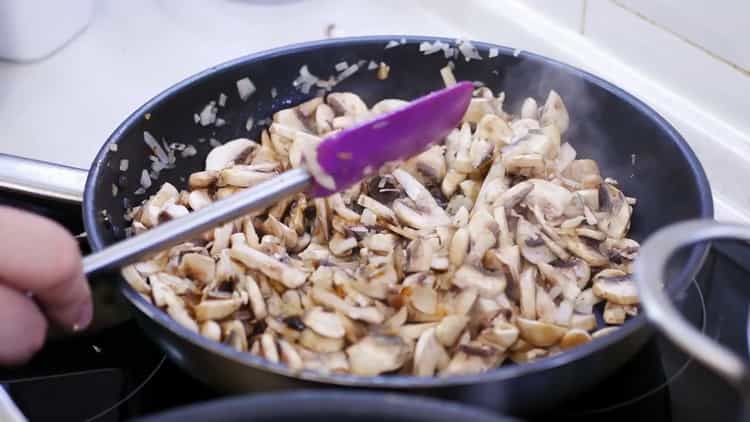 Per preparare una torta per pizza, tagliare i funghi