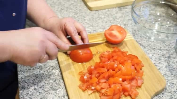 Per cucinare il pesce, tagliare i pomodori greci