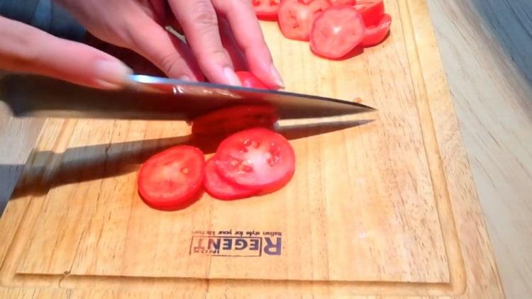 Per preparare le bistecche di salmone rosa, tagliare i pomodori