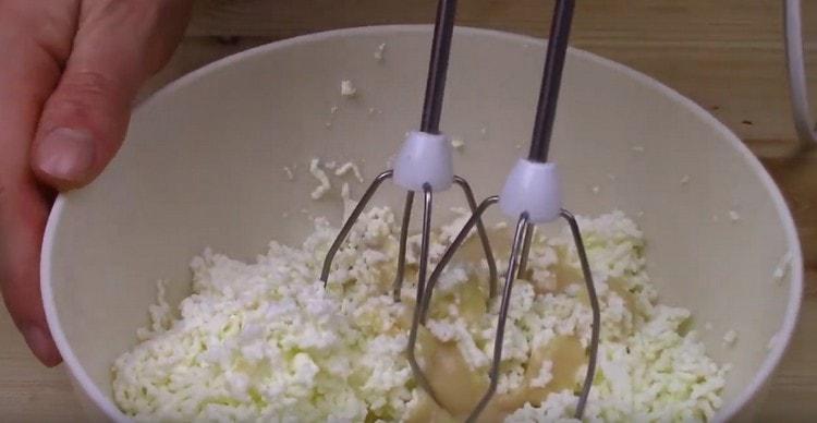 Aggiungi lo zucchero vanigliato, il latte condensato alla cagliata e batti anche con un mixer.