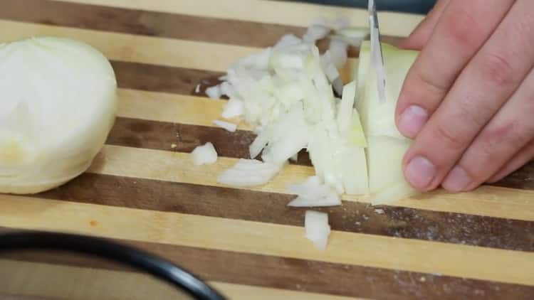 Per preparare un sandwich al tonno, tagliare la cipolla