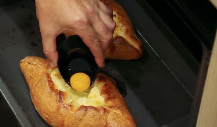 Aggiungi il tuorlo per preparare il khachapuri con uovo e formaggio