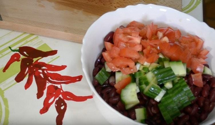 Metti i fagioli in una ciotola, aggiungi i cetrioli e i pomodori.