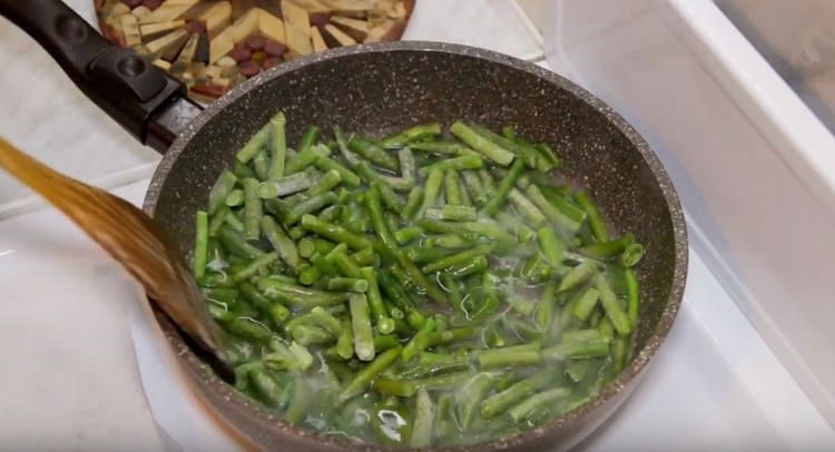 I fagioli vengono inviati nella padella e aggiungere acqua.