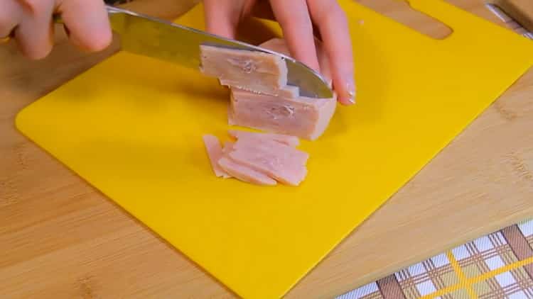 Tritare il prosciutto per fare l'insalata di pasta