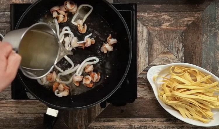 Aggiungi il brodo di pesce per preparare le fettuccine