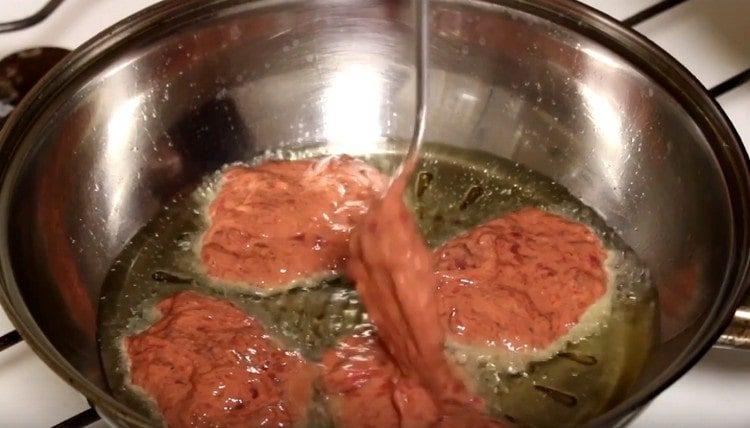 Distribuiamo l'impasto con un cucchiaio nella padella, formando delle cotolette rotonde.