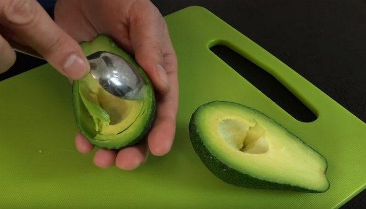 Con attenzione con un cucchiaio, seleziona la carne dall'avocado.