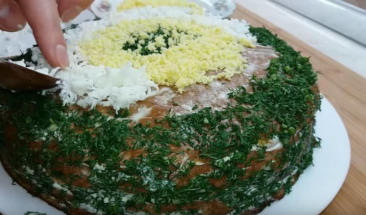 Decorare la torta con aneto tritato e uovo grattugiato.