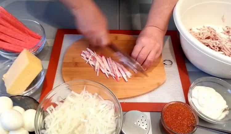 Per cucinare, taglia i bastoncini di granchio