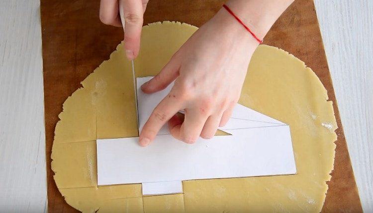 Usando un pezzo di carta, abbiamo ritagliato le figure dall'impasto.